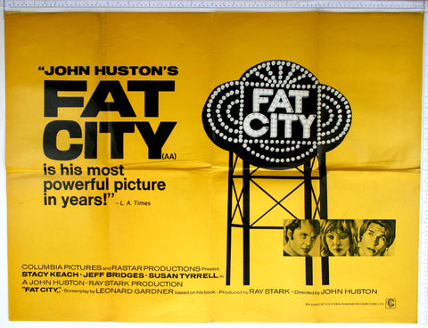 On yellow, illuminated sign of 'fat city' on gantry - three small box illustrations of Keach, Tyrell and Bridges. 