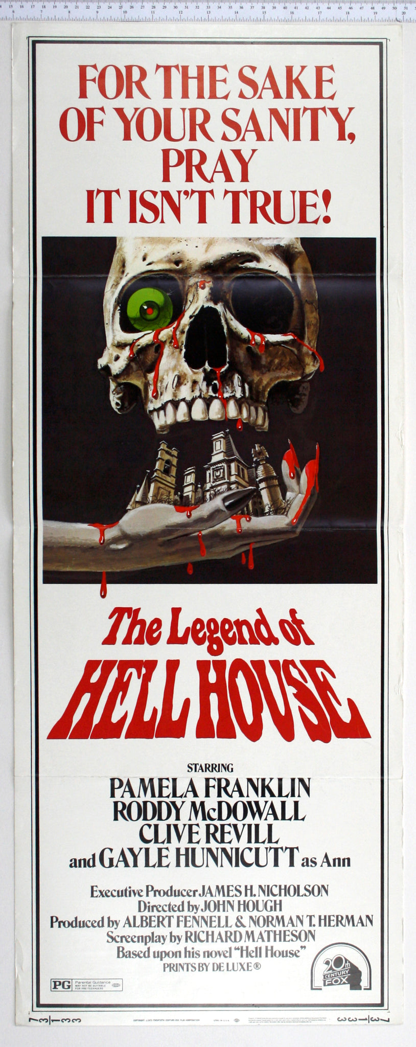A bloody skull with one eyeball and dripping blood, sits over a hand holding Hell House.