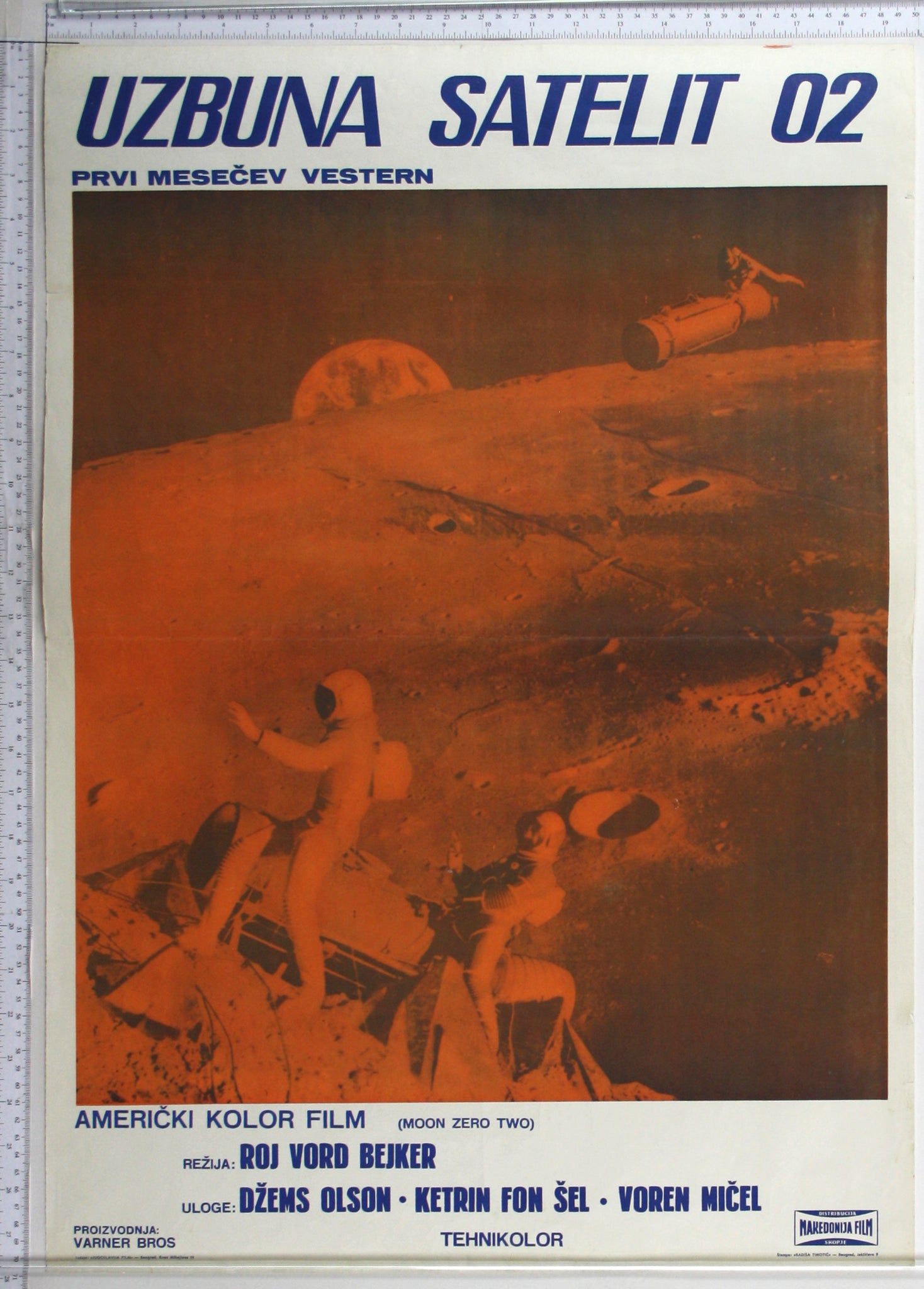 Inset orange photo of lunar landscape, with spacemen on moon tractor, another riding small satellite, with Earth at rear.