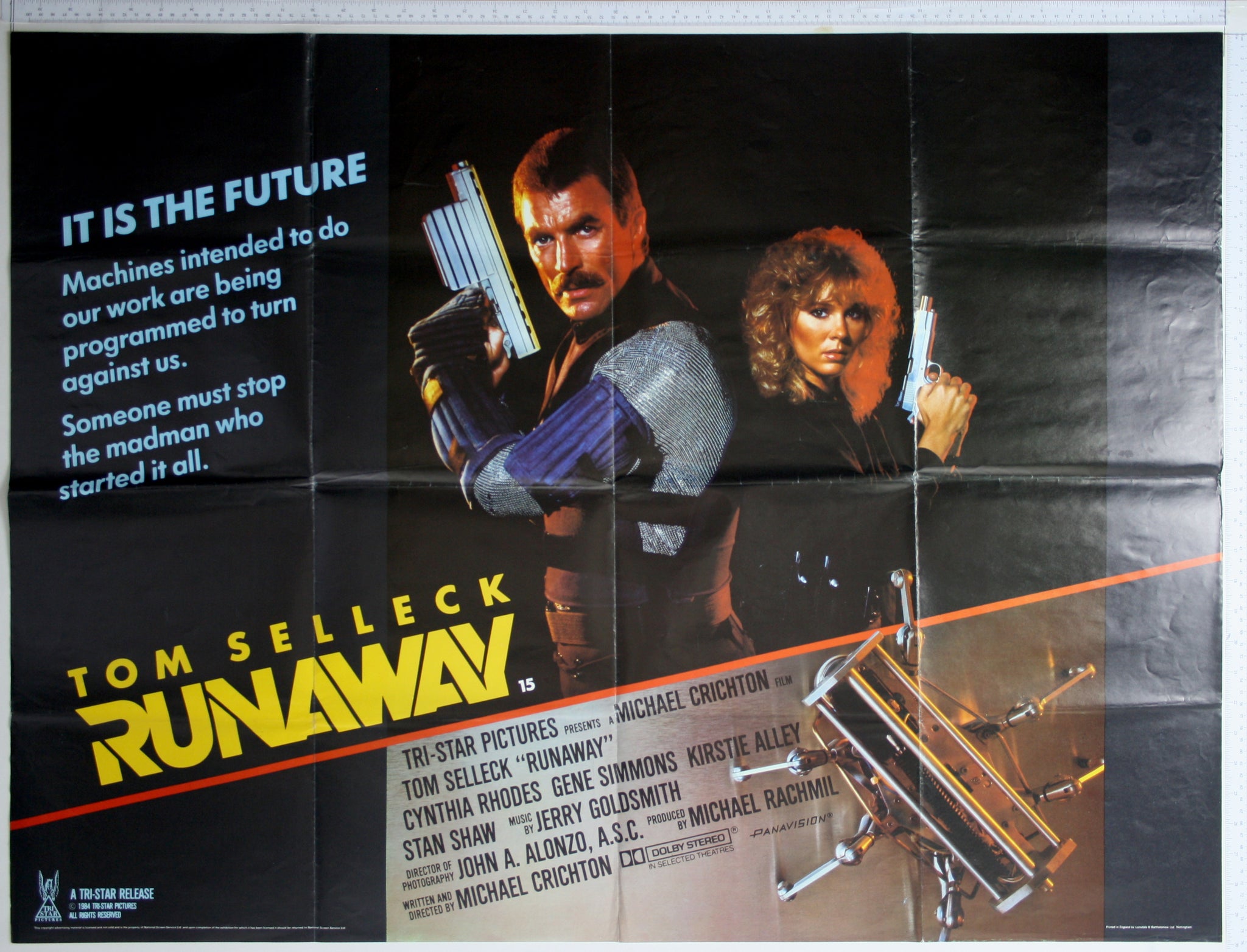 Selleck and Rhodes back to back, holding futuristic guns, with killer robot at bottom.