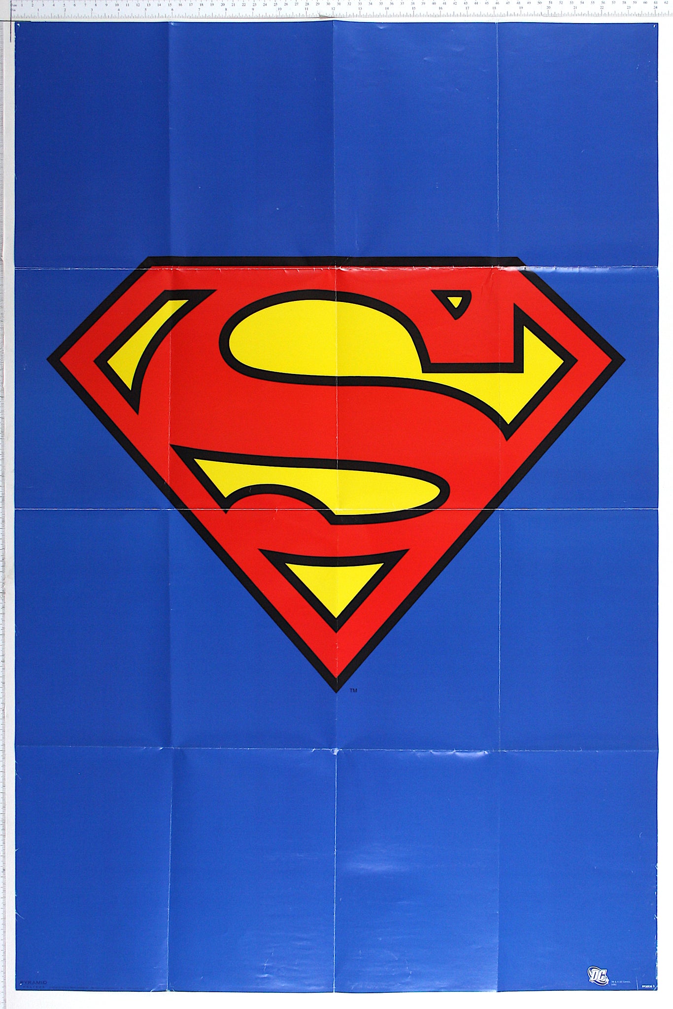 On blue background, the famous red 'S' for Superman, against yellow.