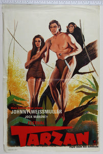 Tarzan stands in tree with knife, Jane holds onto his arm and Cheetah behind his shoulder.