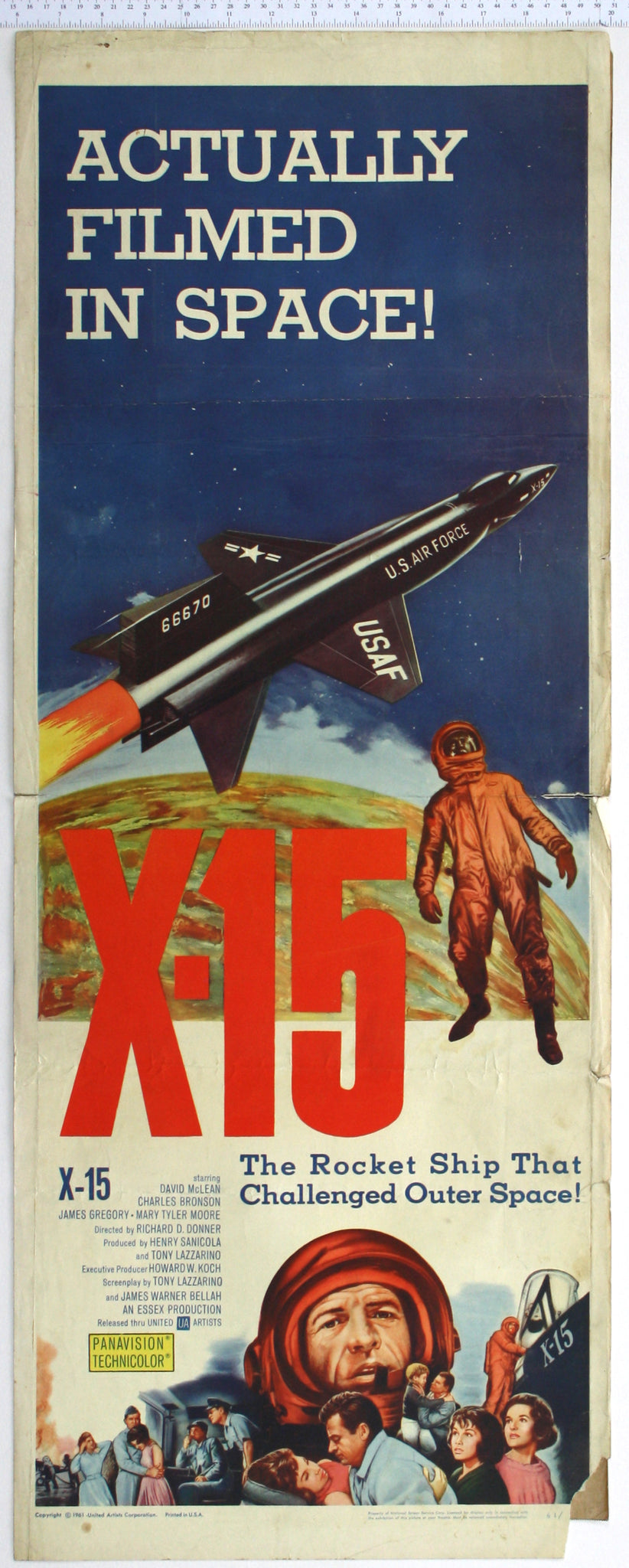 Artwork of air force rocket above the earth, suited pilot, at bottom, pilot and cast.